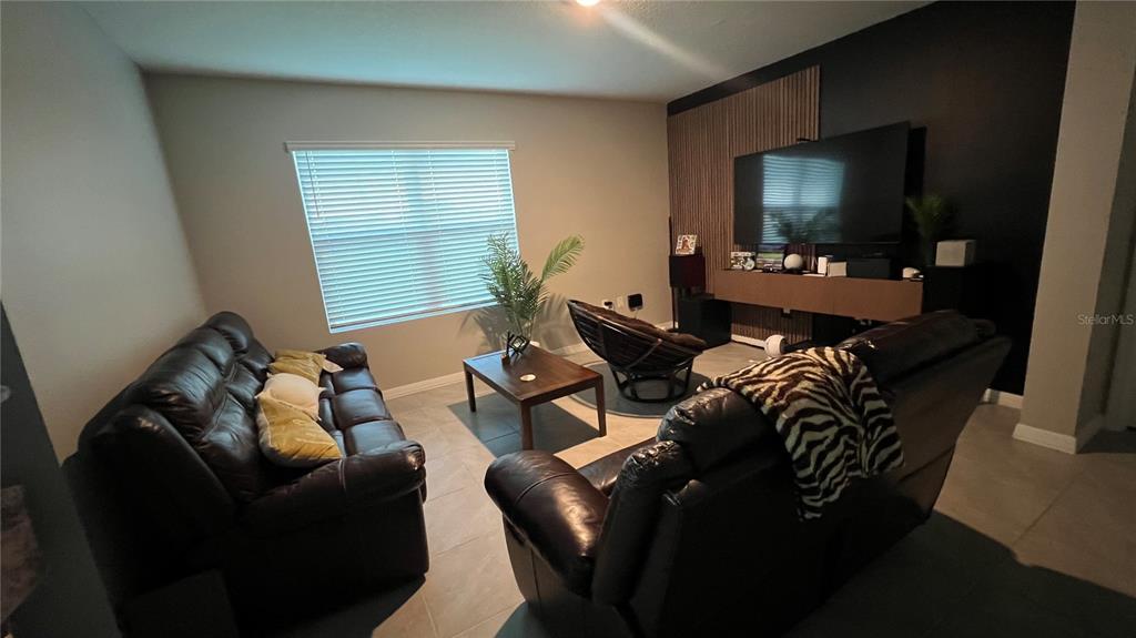 2738 Swooping Sparrow Drive Harmony, FL 34773 - Photo 3 of 9 a living room with furniture and a flat screen tv
