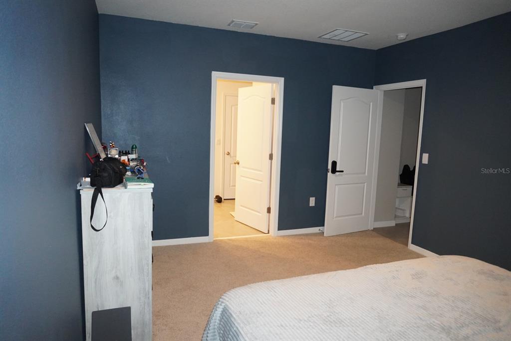 2738 Swooping Sparrow Drive Harmony, FL 34773 - Photo 5 of 9 a bedroom with a bed and a dresser