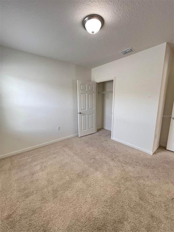 2738 Swooping Sparrow Drive Harmony, FL 34773 - Photo 6 of 9 an empty room with a natural light