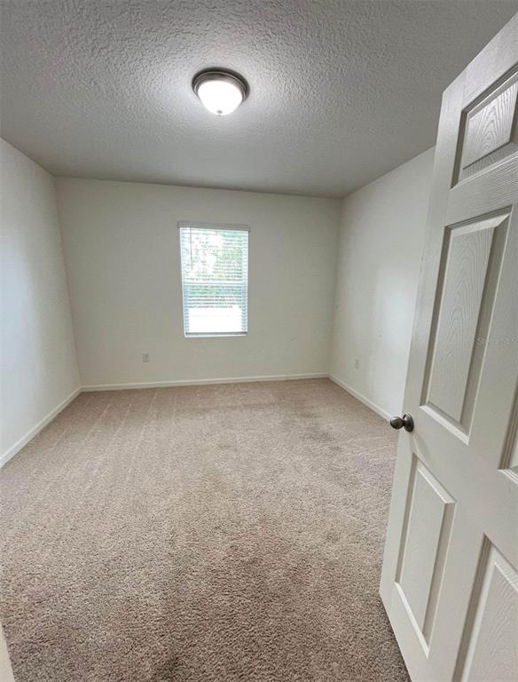 2738 Swooping Sparrow Drive Harmony, FL 34773 - Photo 7 of 9 an empty room with a window