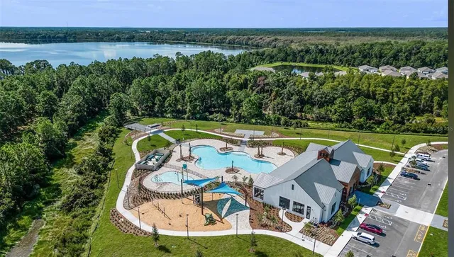 an aerial view of a house with a lake view