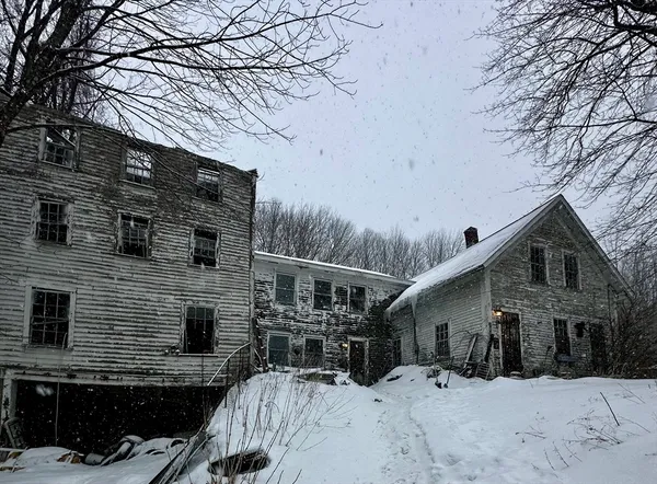 a view of a house with a snow on the road
