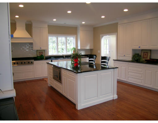 183 Middlesex Road Brookline, MA 02467 - Photo 8 of 16 a kitchen with stainless steel appliances kitchen island granite countertop a stove a sink and a microwave