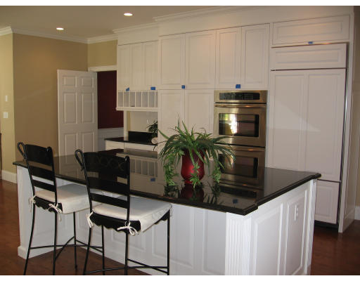 183 Middlesex Road Brookline, MA 02467 - Photo 10 of 16 a kitchen with stainless steel appliances kitchen island granite countertop a refrigerator a stove a sink and white cabinets