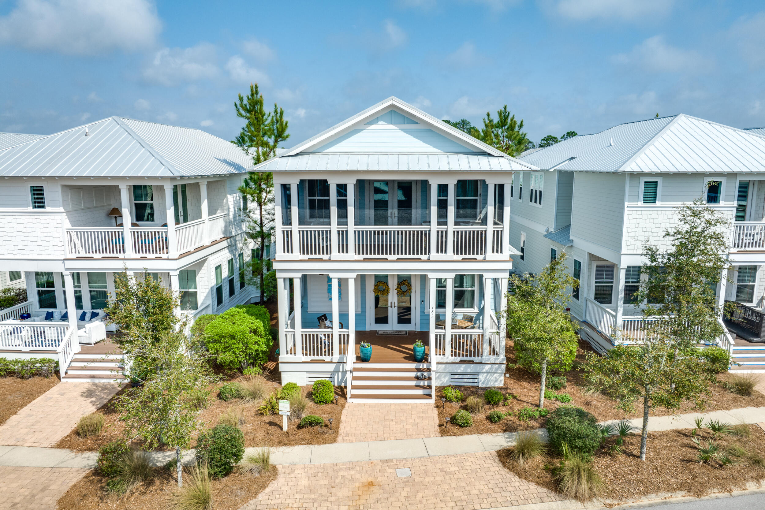 a front view of a house with a garden