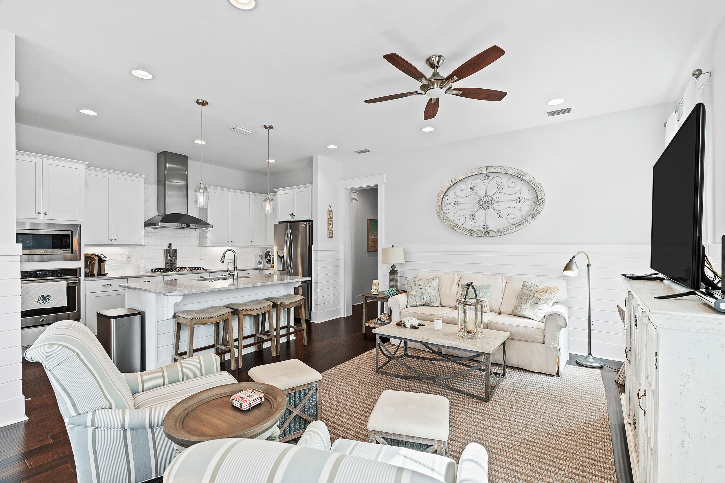 282 Flatwoods Forest Loop Santa Rosa Beach, FL 32459 - Photo 7 of 52 a living room with furniture a clock and a flat screen tv