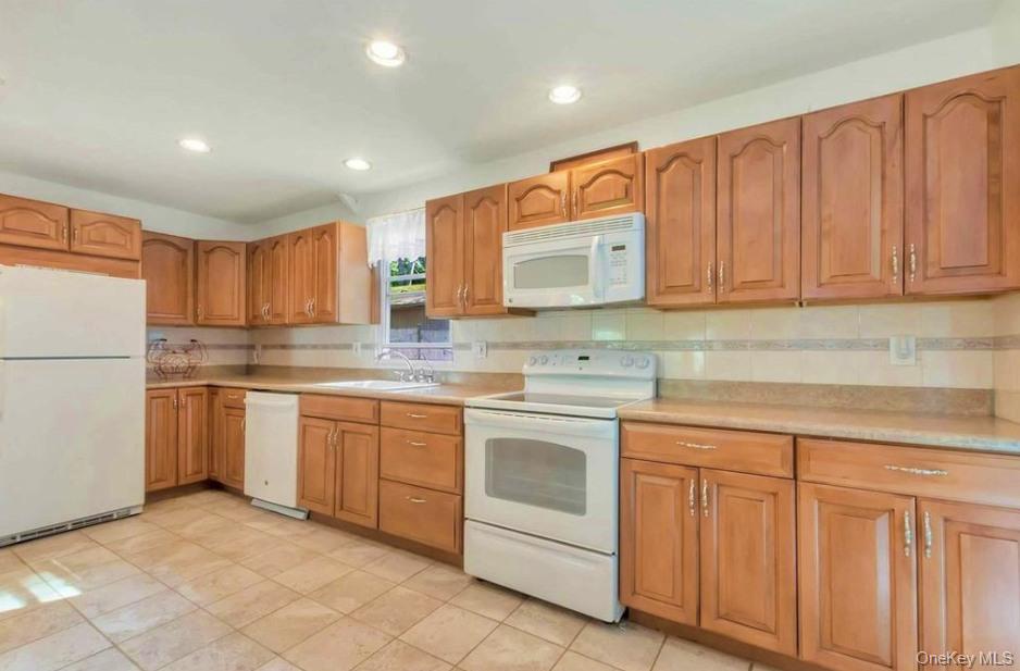 430 Grove Road Southold, NY 11971 - Photo 4 of 15 a kitchen with cabinets appliances a sink and a counter top space
