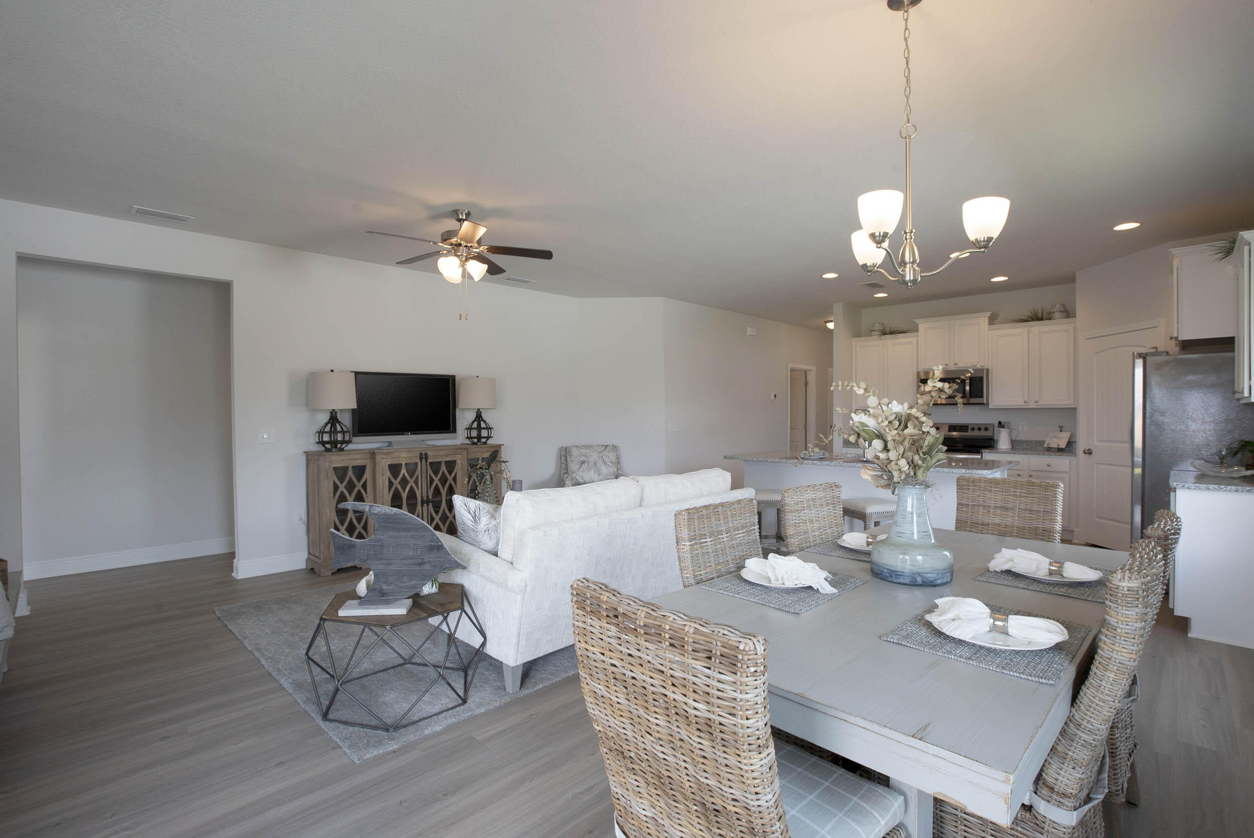 98 Beaver Trl Drive Freeport, FL 32439 - Photo 6 of 18 a view of a dining room with furniture a chandelier and wooden floor