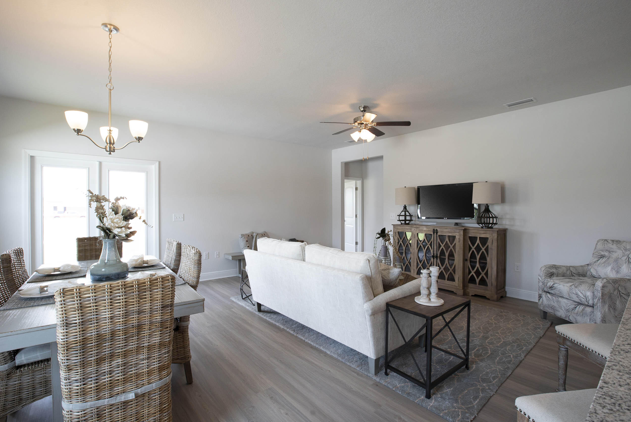 98 Beaver Trl Drive Freeport, FL 32439 - Photo 7 of 18 a living room with furniture a chandelier and a flat screen tv
