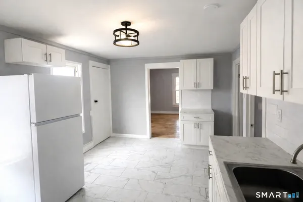 a kitchen with refrigerator and window
