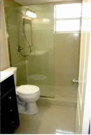 a bathroom with a toilet and a shower