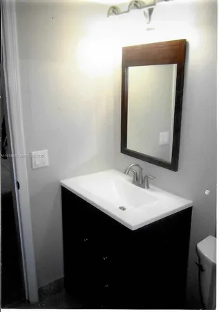 a bathroom with a sink vanity and a mirror
