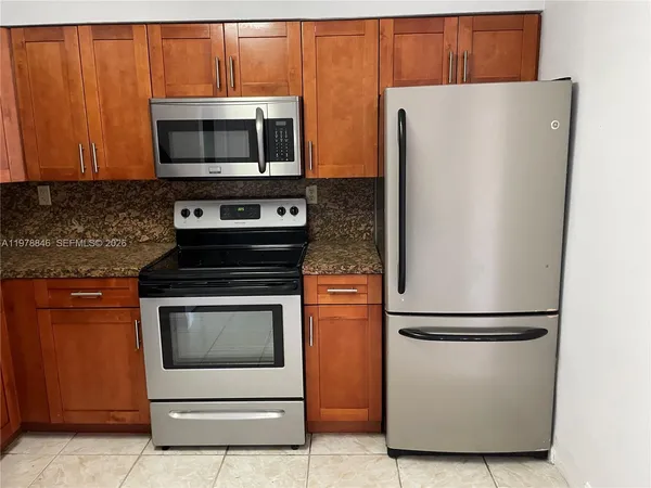 a kitchen with appliances and cabinets