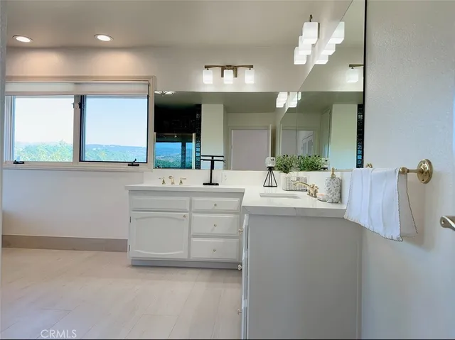 a bathroom with a sink vanity and mirror