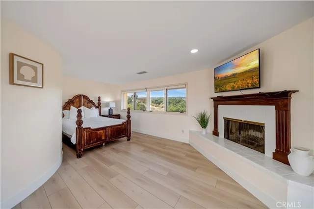 a bedroom with furniture and a fireplace
