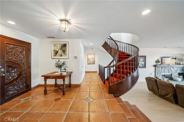 a living room with furniture a rug and a wall painting