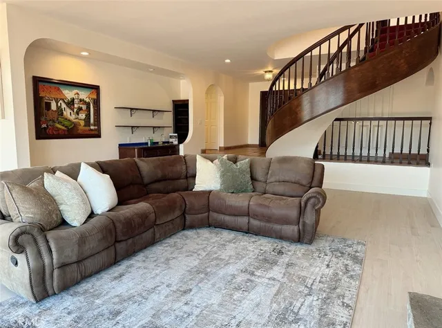 a living room with furniture ceiling fan and a rug
