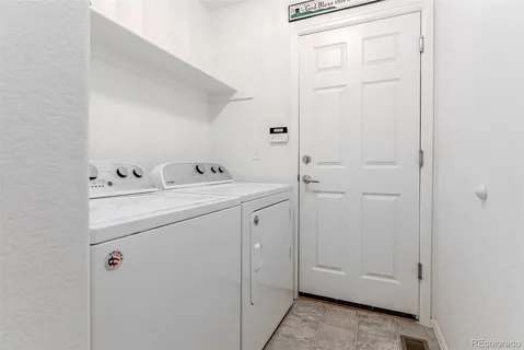 a front view of a house with a garden and trees