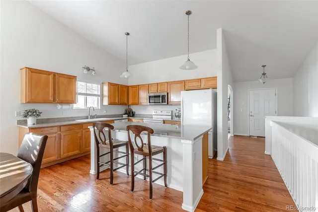 a kitchen with stainless steel appliances granite countertop wooden cabinets a sink and a large window