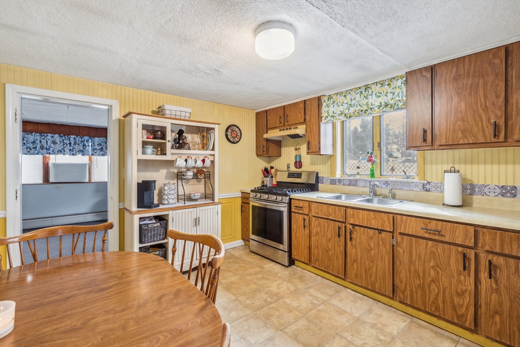 20 Hemlock Road Holbrook, MA 02343 - Photo 18 of 32 a kitchen with stainless steel appliances granite countertop a stove and a sink