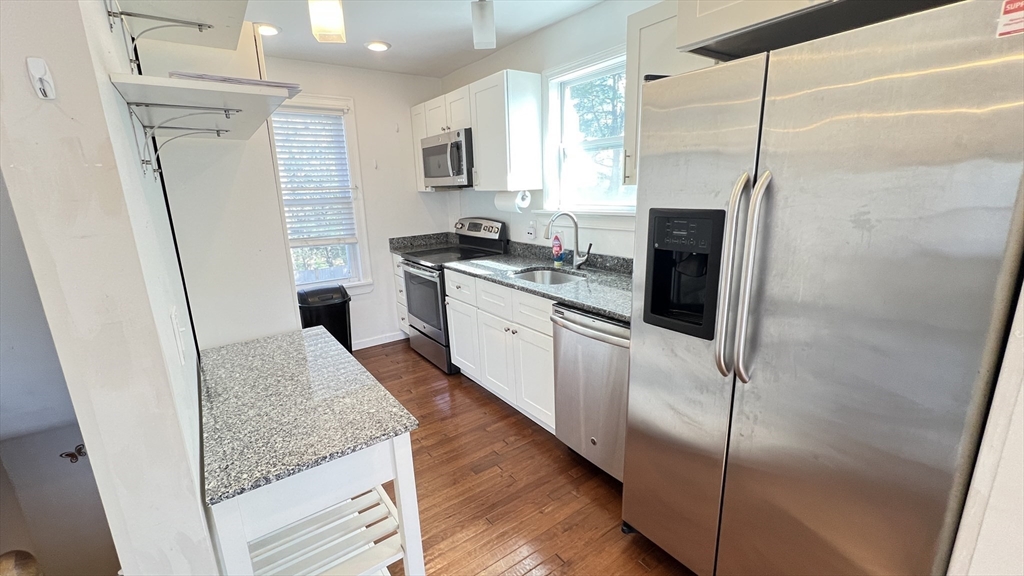 3 Mill St Court, Unit 2 Danvers, MA 01923 - Photo 1 of 23 a kitchen with stainless steel appliances granite countertop a refrigerator a sink and a stove
