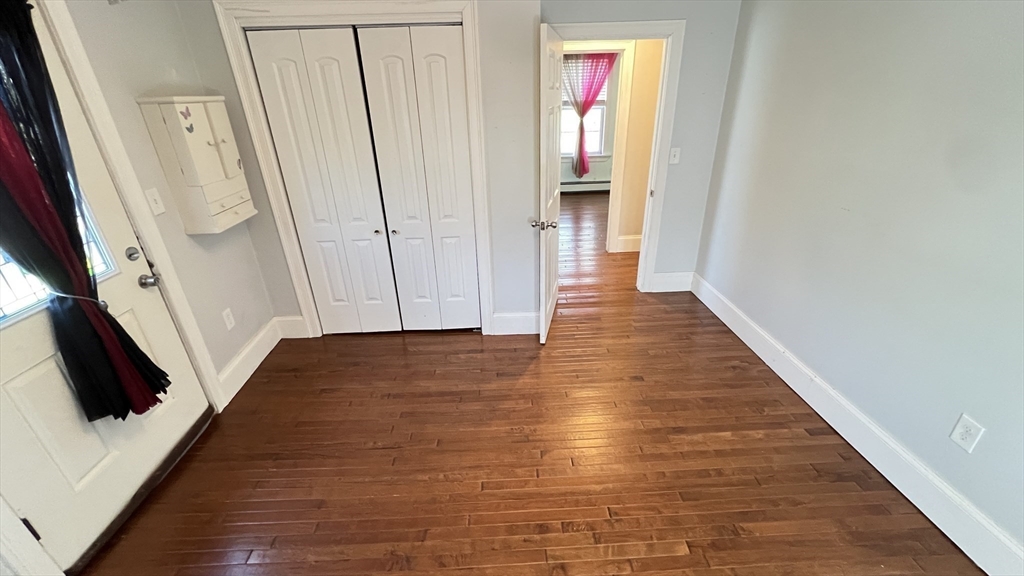 3 Mill St Court, Unit 2 Danvers, MA 01923 - Photo 15 of 23 a view of a hallway with wooden floor and staircase
