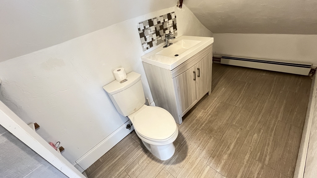3 Mill St Court, Unit 2 Danvers, MA 01923 - Photo 22 of 23 a bathroom with a toilet sink and mirror