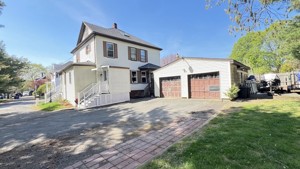 3 Mill St Court, Unit 2 Danvers, MA 01923 - Photo 23 of 23 a front view of a house with a yard and garage