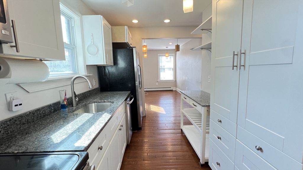 3 Mill St Court, Unit 2 Danvers, MA 01923 - Photo 4 of 23 a kitchen with stainless steel appliances a refrigerator and a sink