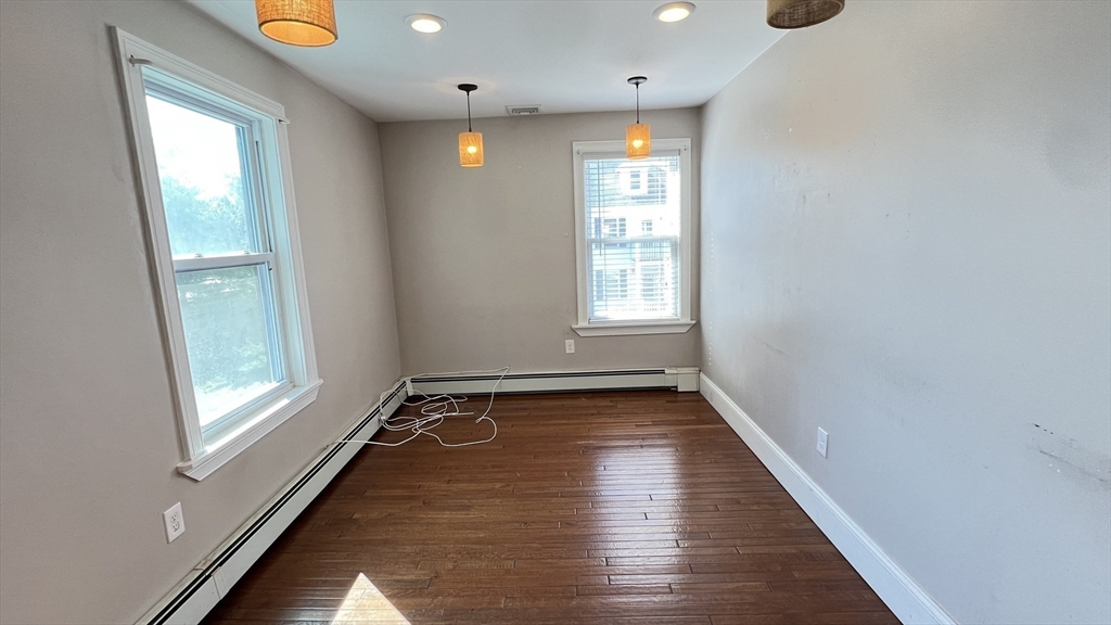 3 Mill St Court, Unit 2 Danvers, MA 01923 - Photo 6 of 23 a view of an empty room with glass door and wooden floor