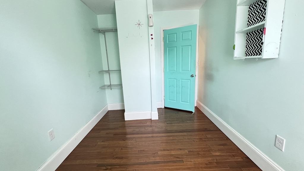 3 Mill St Court, Unit 2 Danvers, MA 01923 - Photo 9 of 23 a view of a hallway with wooden floor and closet