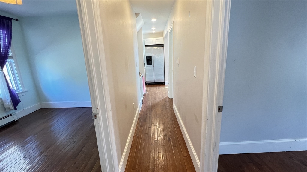 3 Mill St Court, Unit 2 Danvers, MA 01923 - Photo 10 of 23 a view of a hallway with wooden floor and a bathroom
