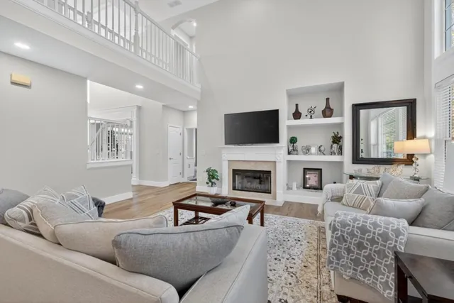 a living room with furniture a fireplace and a flat screen tv