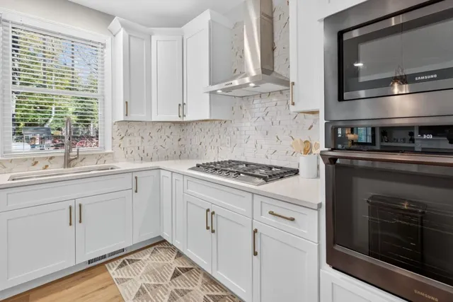 a kitchen with cabinets and appliances