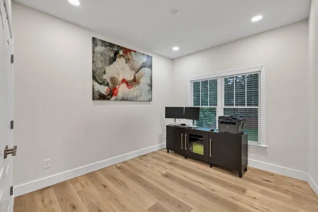 a view of workspace with wooden floor and window