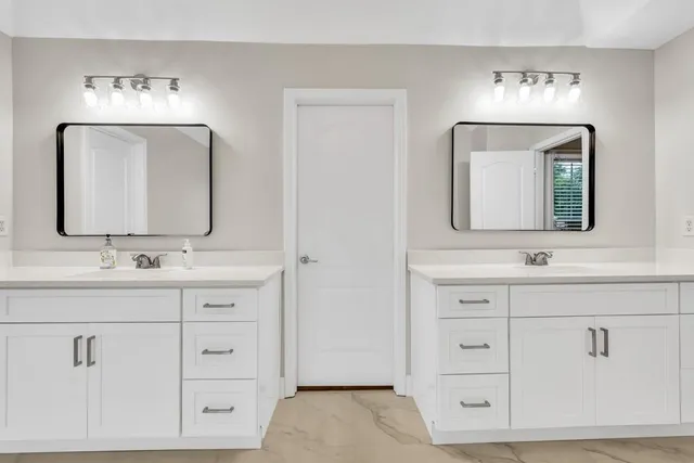 a spacious bedroom with a large bed and a fireplace