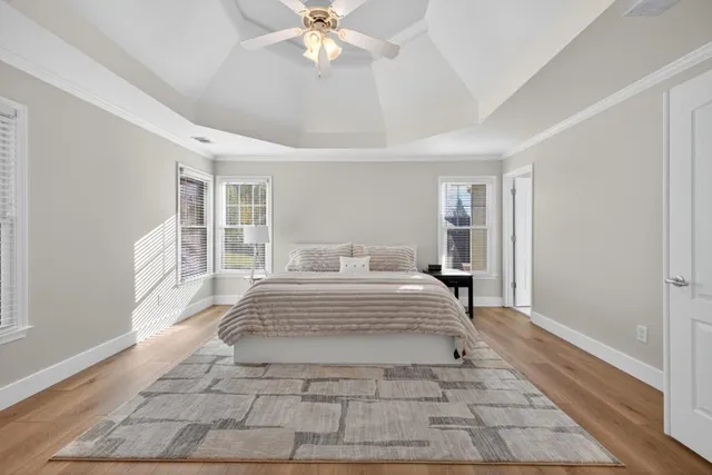 a bedroom with a bed and wooden floor