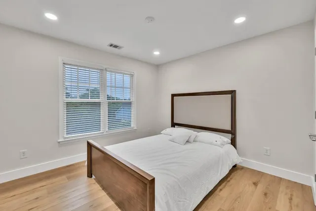 a bathroom with a sink a toilet a shower and a mirror