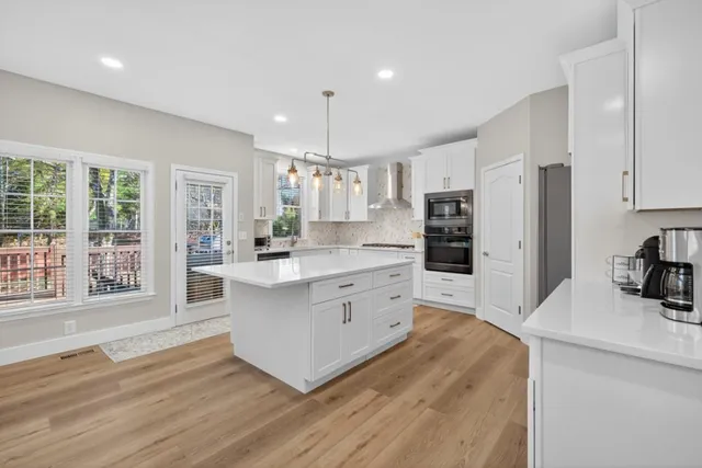 a kitchen with stainless steel appliances a refrigerator and a stove top oven
