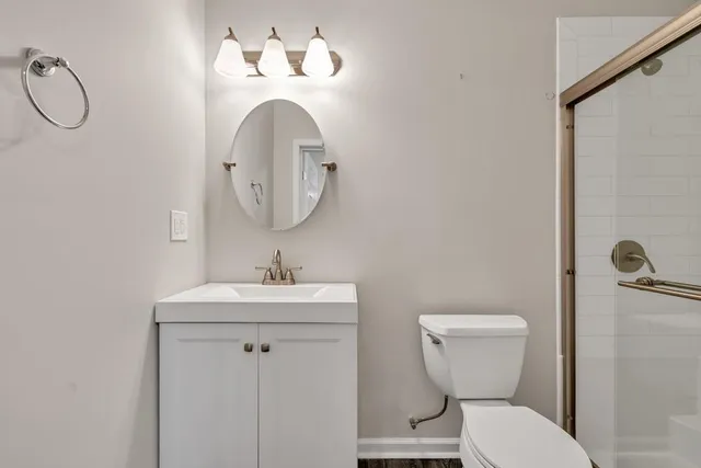 a view of an empty room and kitchen view