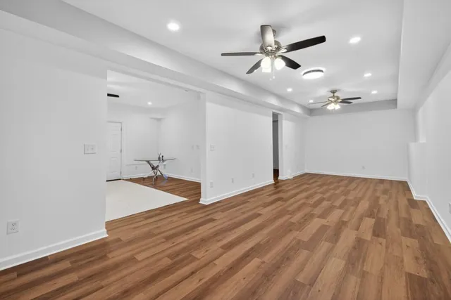 a view of a park with a small yard and large trees