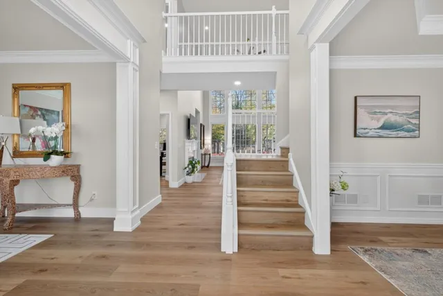a view of entryway and hall with wooden floor