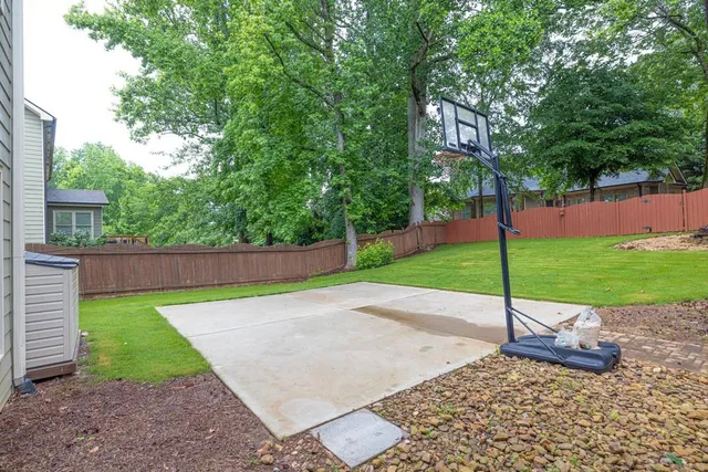 a view of a house with pool and sitting area