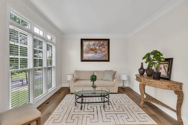 a living room with furniture and a floor to ceiling window