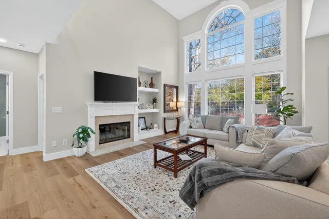 a living room with furniture a fireplace and a flat screen tv