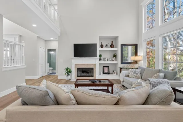 a living room with furniture a fireplace and a flat screen tv