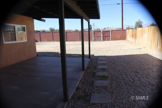 329 Lenore Street Ridgecrest, CA 93555 - Photo 22 of 28 a view of a living room and a floor to ceiling window