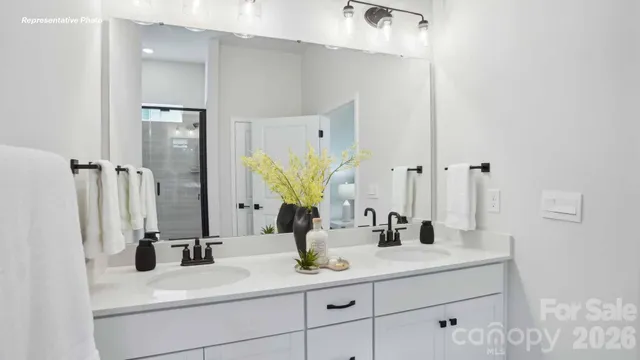 a bathroom with a double vanity sink and mirror