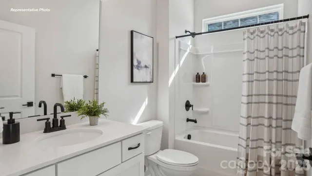 a bathroom with a sink a toilet a tub and shower