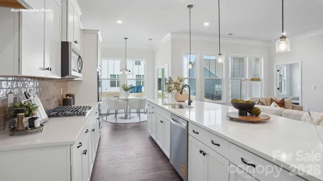 a kitchen with counter top space a sink stainless steel appliances and cabinets